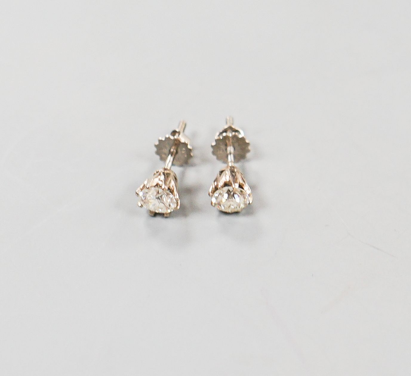 A pair of 18ct white metal and solitaire diamond ear studs, gross weight 2.4 grams